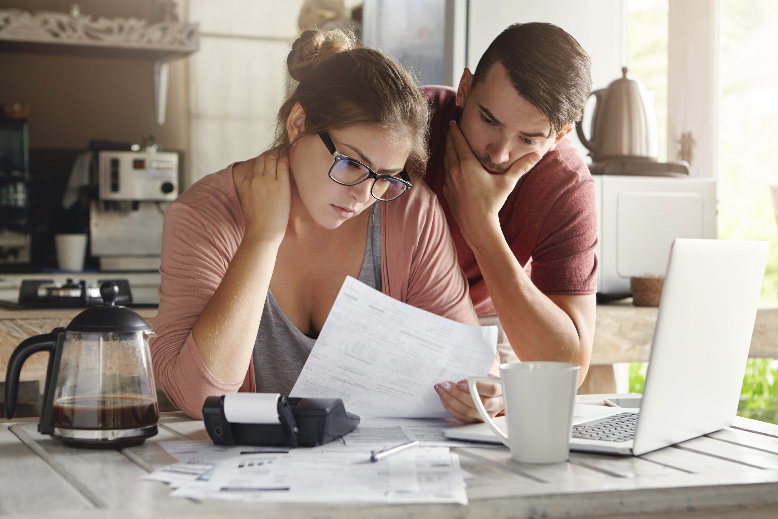 photo of a couple counting their bills to denote a story about payday and Brits having no cash left at the end of the month