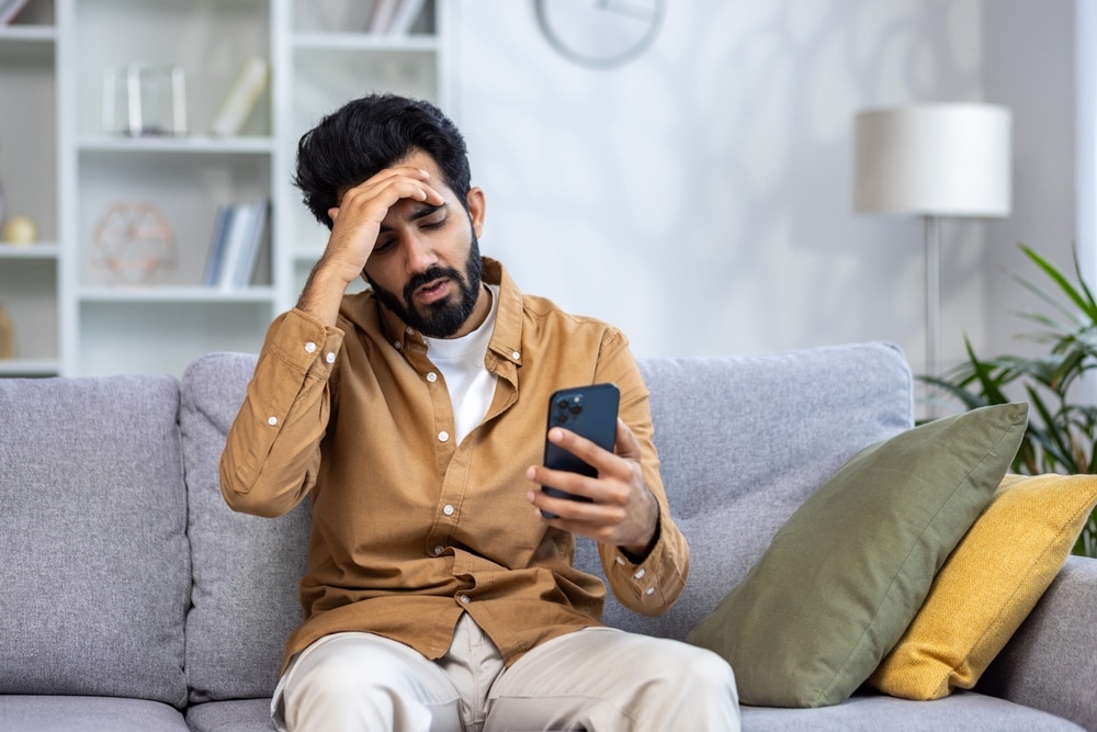 unhappy person on the phone to denote the number of ombudsman complaints rising